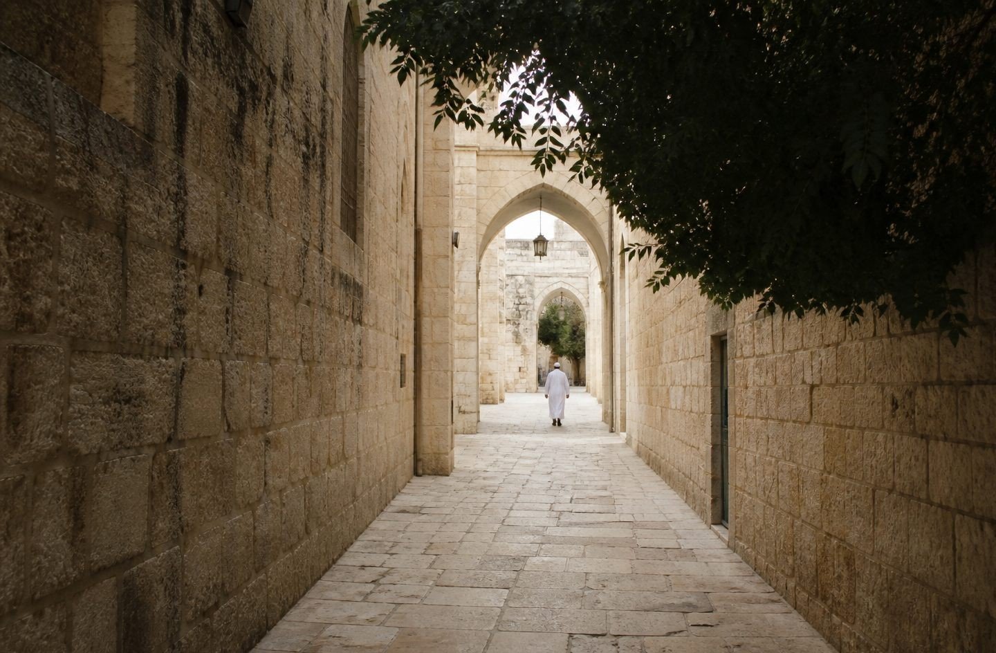 A narrow stone passage opening toward brighter light